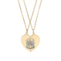 Gold heart-shaped necklace with engraved design on a white background