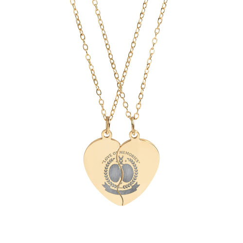 Gold heart-shaped necklace with engraved design on a white background