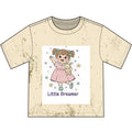 Beige t-shirt with a graphic of a girl in a pink dress holding a bunny and the text 'Little Dreamer' on a white background.