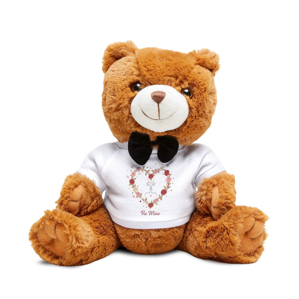 Brown teddy bear wearing a white shirt with a floral design and text on a white background